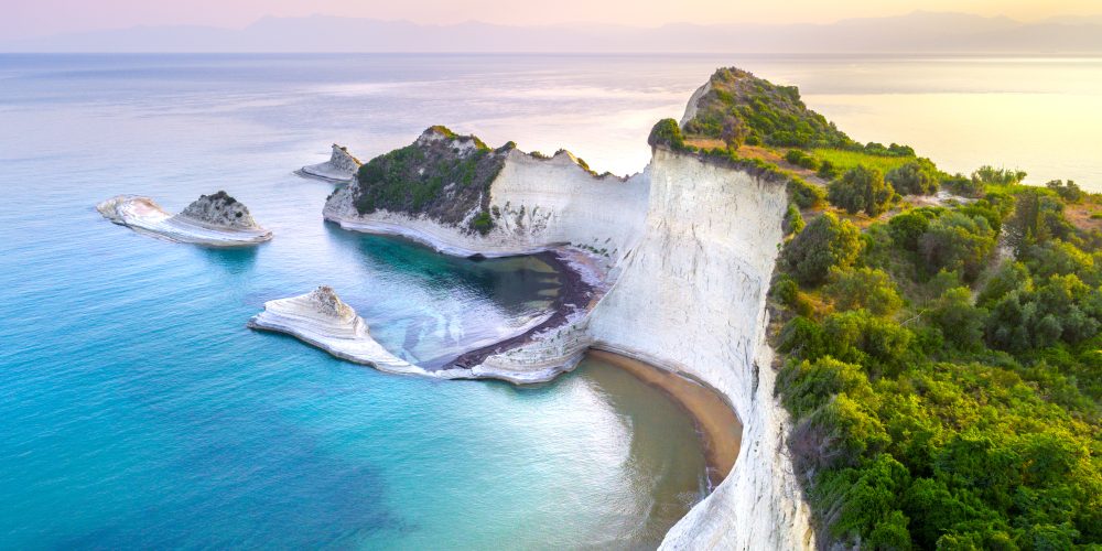 Cape Drastis on Corfu Island features stunning white cliffs and turquoise waters, offering breathtaking views and a sense of tranquility