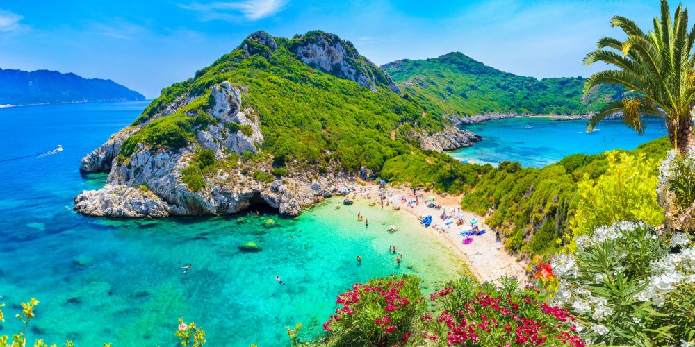 Porto Timoni on Corfu Island is a hidden paradise with twin beaches, crystal-clear waters, and lush green landscapes